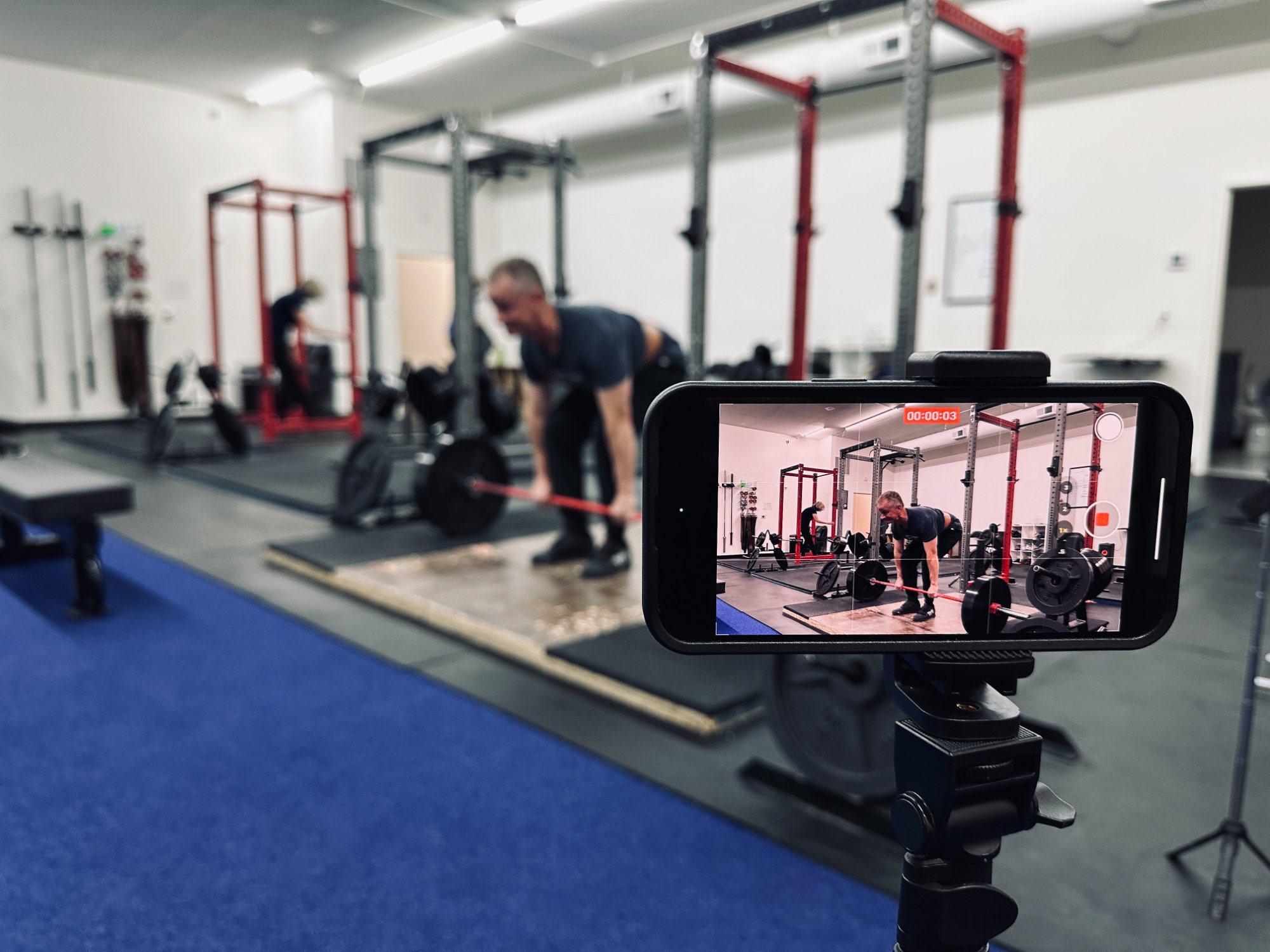 Coach filming a deadlift at Ground Zero Strength